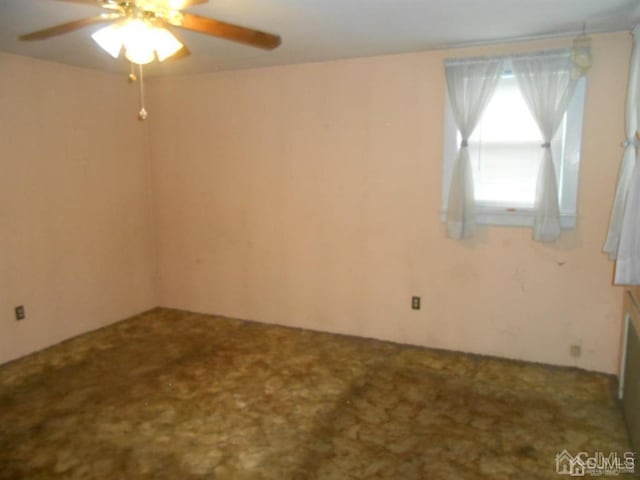 carpeted empty room with ceiling fan