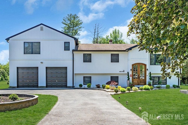 24 Bentley Rd, Monroe, NJ 08831 - tri-level home featuring french doors, asphalt driveway, a garage, a front lawn, and a chimney