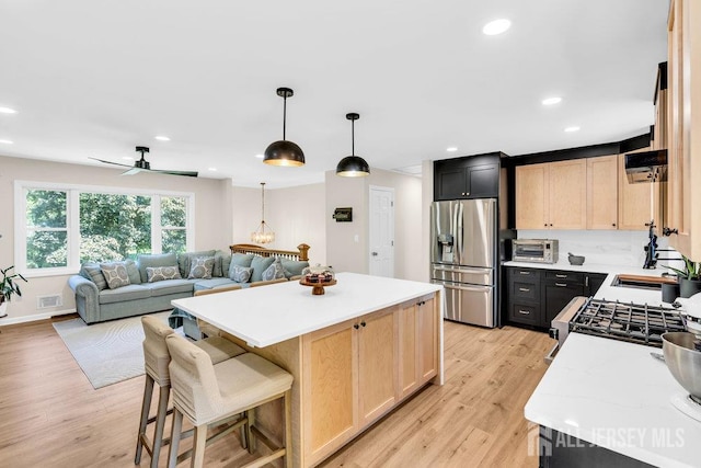 24 Bentley Rd, Monroe, NJ 08831 - kitchen featuring stainless steel refrigerator with ice dispenser, light brown cabinets, a center island, open floor plan, and recessed lighting