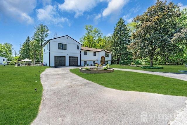 24 Bentley Rd, Monroe, NJ 08831 - view of front of home featuring an attached garage, asphalt driveway, and a front lawn