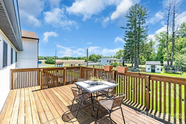 24 Bentley Rd, Monroe, NJ 08831 - wooden terrace featuring a trampoline, outdoor dining area, and a yard