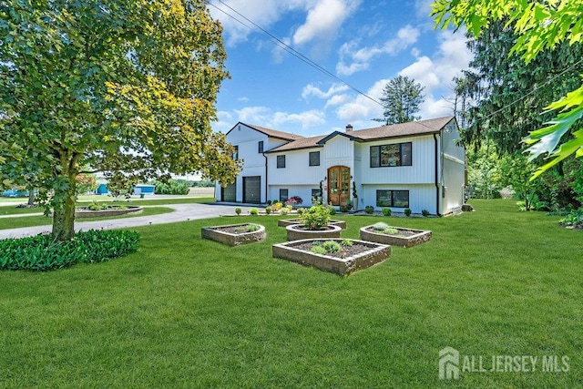 24 Bentley Rd, Monroe, NJ 08831 - rear view of house featuring asphalt driveway, an attached garage, and a yard