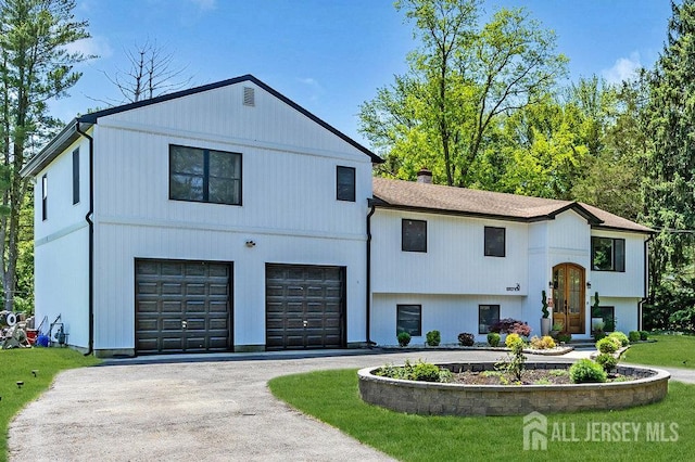 24 Bentley Rd, Monroe, NJ 08831 - view of front of house featuring a garage, asphalt driveway, a chimney, and a front yard