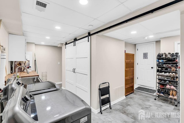 24 Bentley Rd, Monroe, NJ 08831 - washroom with a barn door, baseboards, washer and clothes dryer, and recessed lighting