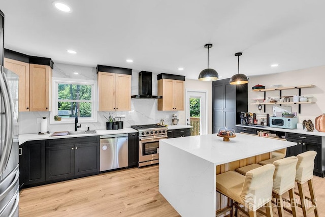 24 Bentley Rd, Monroe, NJ 08831 - kitchen featuring appliances with stainless steel finishes, wall chimney exhaust hood, light countertops, light brown cabinets, and recessed lighting