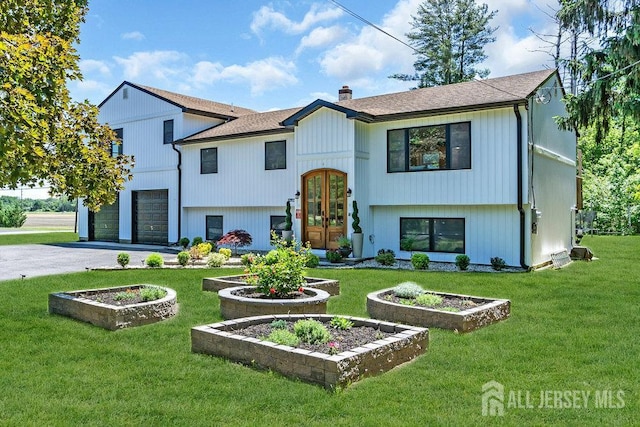 24 Bentley Rd, Monroe, NJ 08831 - view of front of home with a garage, driveway, french doors, a front lawn, and a shingled roof