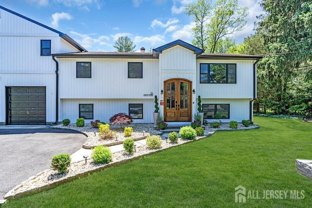 24 Bentley Rd, Monroe, NJ 08831 - bi-level home featuring french doors, a front yard, a chimney, and asphalt driveway