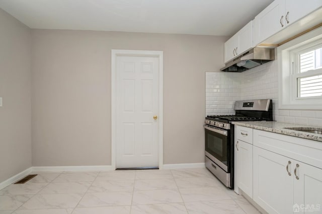 23 Hazelhurst St, New Brunswick, NJ 08901 - kitchen featuring stainless steel range with gas stovetop, under cabinet range hood, light marble finish floors, and light stone counters