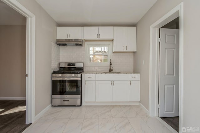 23 Hazelhurst St, New Brunswick, NJ 08901 - kitchen featuring under cabinet range hood, stainless steel gas stove, tasteful backsplash, white cabinets, and light stone countertops