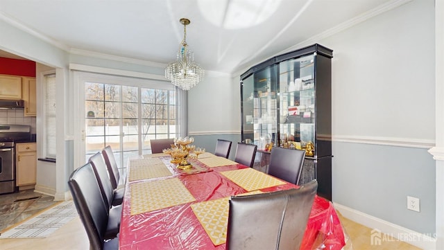 dining space featuring baseboards, ornamental molding, and a chandelier