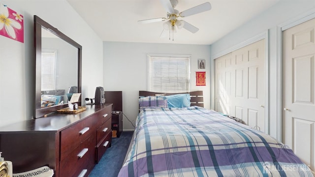 bedroom with a ceiling fan, dark colored carpet, a closet, and baseboards