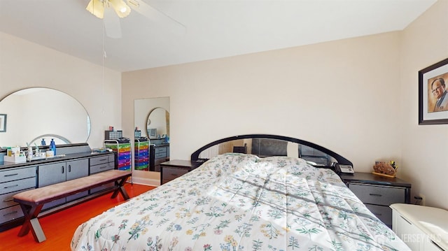 bedroom with ceiling fan and wood finished floors