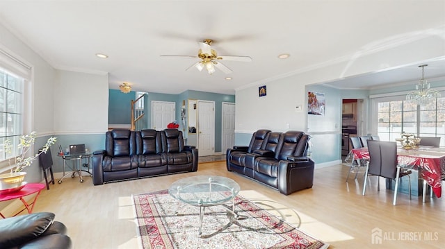 living area featuring light wood finished floors, recessed lighting, stairway, and ornamental molding