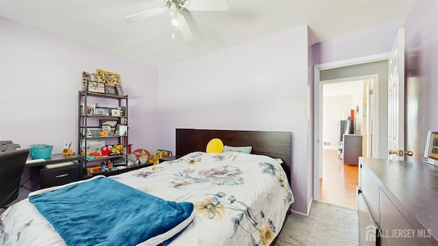 bedroom with light carpet and a ceiling fan