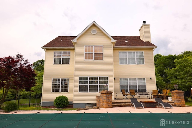 19 Crescent Rd, Old Bridge, NJ 08857 - back of property with a patio area and a chimney