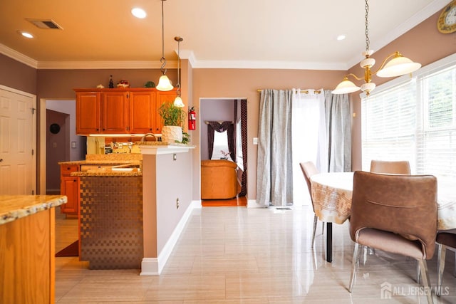 19 Crescent Rd, Old Bridge, NJ 08857 - kitchen featuring crown molding, pendant lighting, light stone counters, brown cabinetry, and baseboards