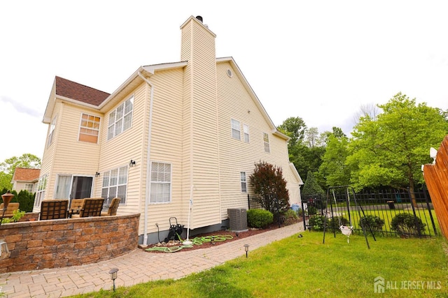 19 Crescent Rd, Old Bridge, NJ 08857 - view of home's exterior featuring a chimney, a patio, and central AC