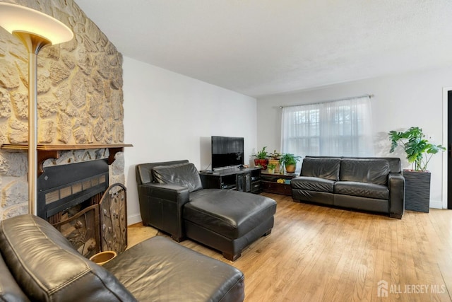 1 Pheasant Run, Edison, NJ 08820 - living area featuring a stone fireplace and light wood-style flooring