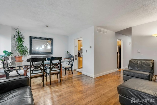 1 Pheasant Run, Edison, NJ 08820 - living area with light wood-type flooring, baseboards, visible vents, and a textured ceiling