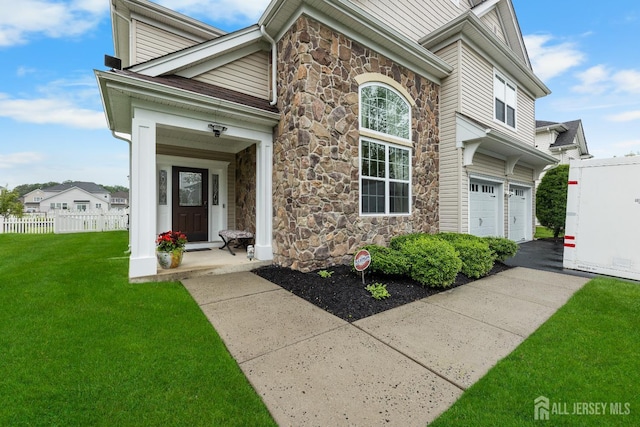 55 Dahlia Ct, Piscataway, NJ 08854 - view of front of property featuring stone siding, a garage, and driveway
