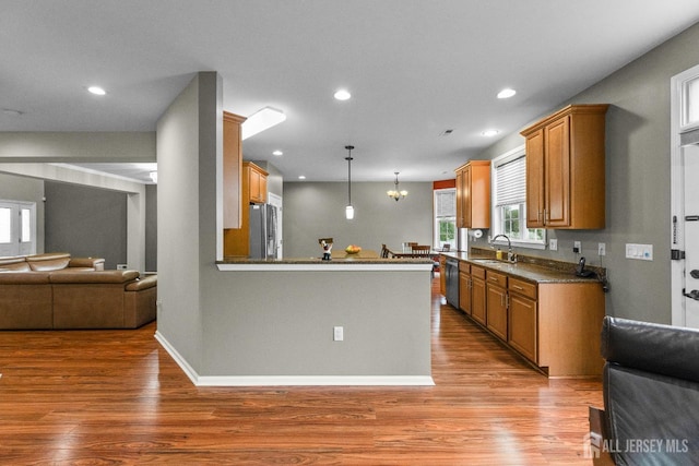 55 Dahlia Ct, Piscataway, NJ 08854 - kitchen with stainless steel appliances, open floor plan, wood finished floors, brown cabinetry, and recessed lighting