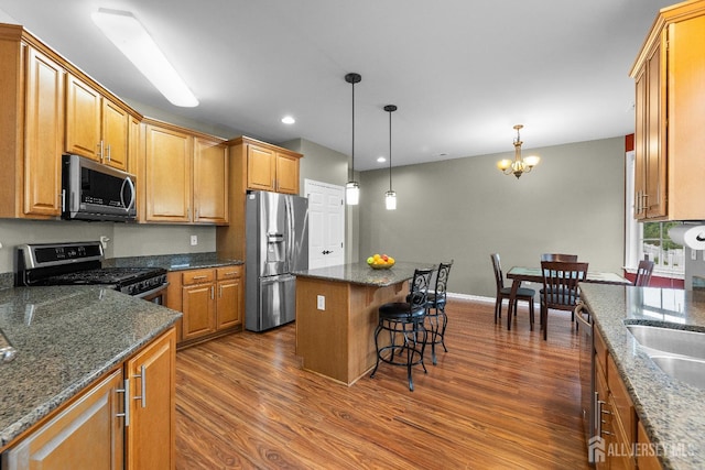 55 Dahlia Ct, Piscataway, NJ 08854 - kitchen with appliances with stainless steel finishes, dark wood-type flooring, a center island, pendant lighting, and a breakfast bar