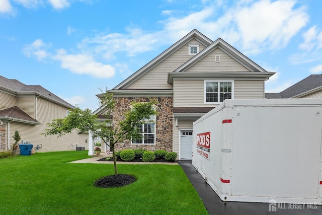 55 Dahlia Ct, Piscataway, NJ 08854 - traditional home featuring stone siding, a front yard, and an attached garage