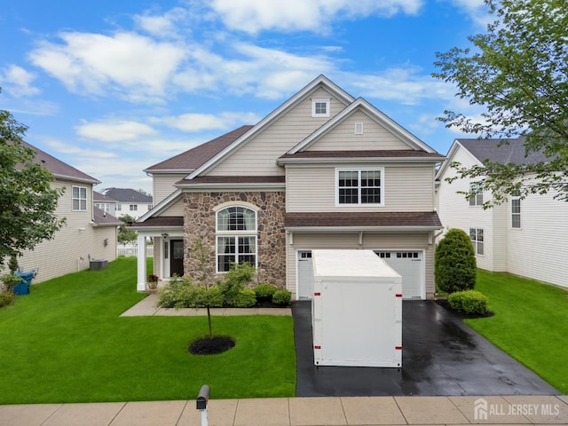 55 Dahlia Ct, Piscataway, NJ 08854 - view of front facade with concrete driveway, a garage, a front lawn, and stone siding