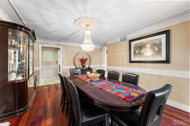 dining space with crown molding and dark wood-type flooring