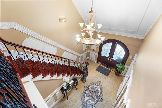 entrance foyer with french doors and a notable chandelier