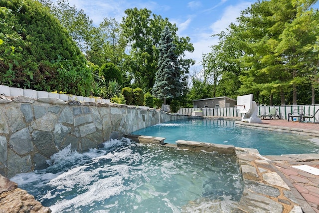 view of pool with a patio and pool water feature