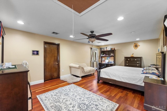 bedroom with visible vents, wood finished floors, recessed lighting, baseboards, and attic access