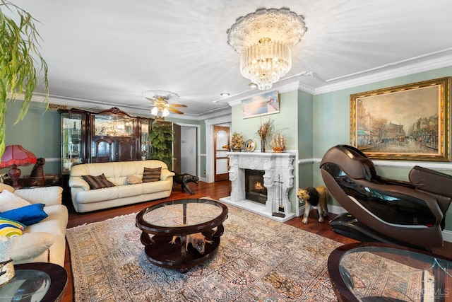 living room featuring crown molding, wood-type flooring, and a notable chandelier