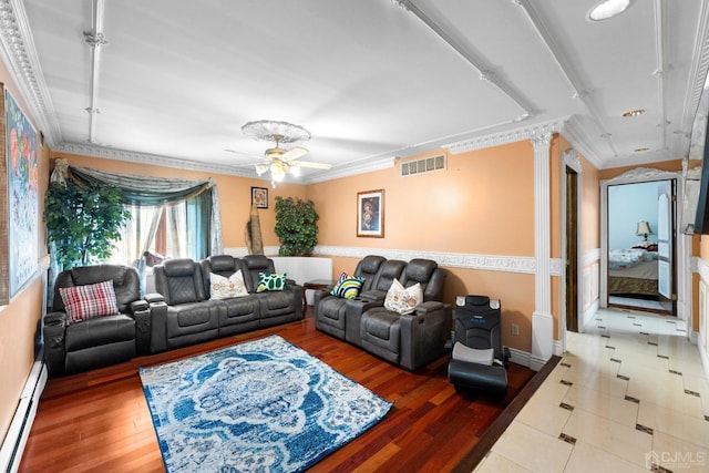 living room featuring crown molding, hardwood / wood-style flooring, ceiling fan, baseboard heating, and decorative columns