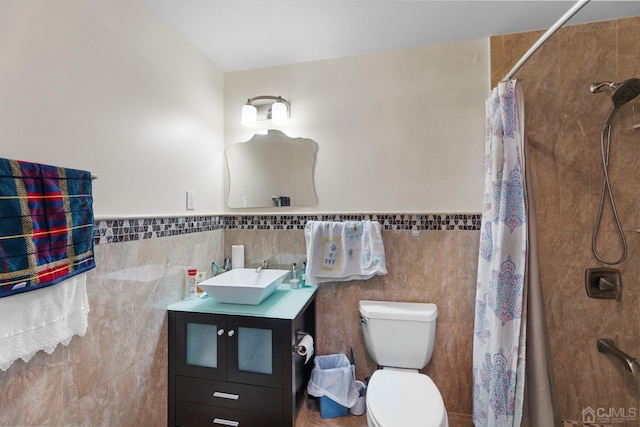 bathroom featuring a shower with curtain, vanity, toilet, and tile walls