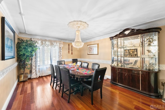 dining room with crown molding and dark hardwood / wood-style floors