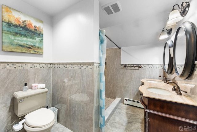 bathroom with toilet, a shower with curtain, tile walls, vanity, and a baseboard heating unit