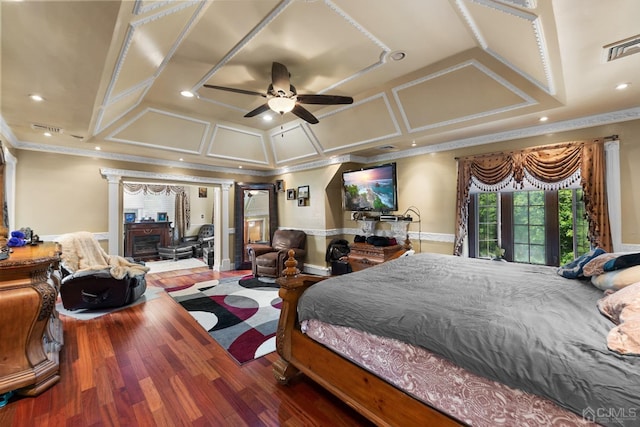 bedroom with crown molding, coffered ceiling, and hardwood / wood-style floors