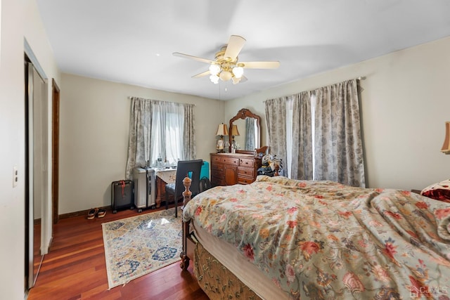 bedroom with ceiling fan, dark hardwood / wood-style floors, and a closet