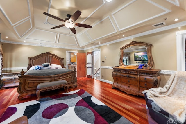 bedroom featuring crown molding, coffered ceiling, and dark hardwood / wood-style flooring