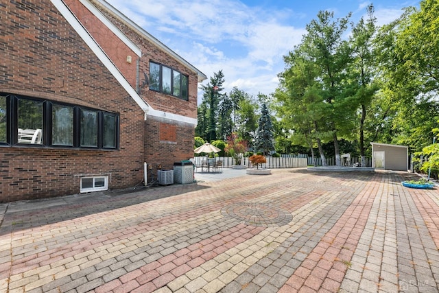 exterior space with central air condition unit and a patio area