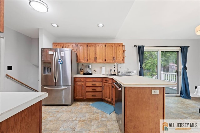 34 Connor Ave, Metuchen, NJ 08840 - kitchen with appliances with stainless steel finishes, a peninsula, stone finish flooring, light countertops, and decorative backsplash