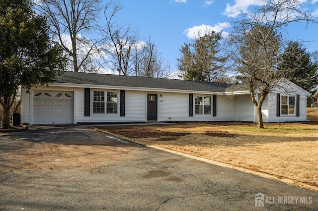 ranch-style house with a front yard and a garage