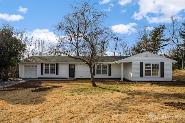 ranch-style house featuring a garage and a front lawn