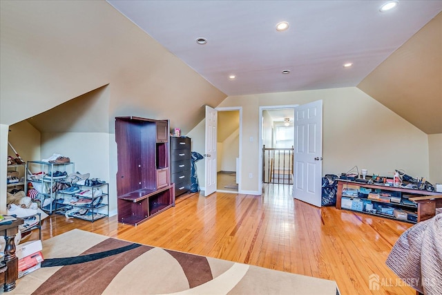 interior space with hardwood / wood-style flooring and vaulted ceiling