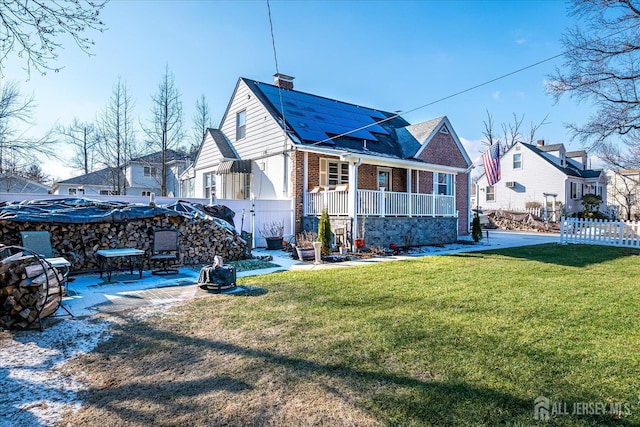 back of property featuring a porch and a yard