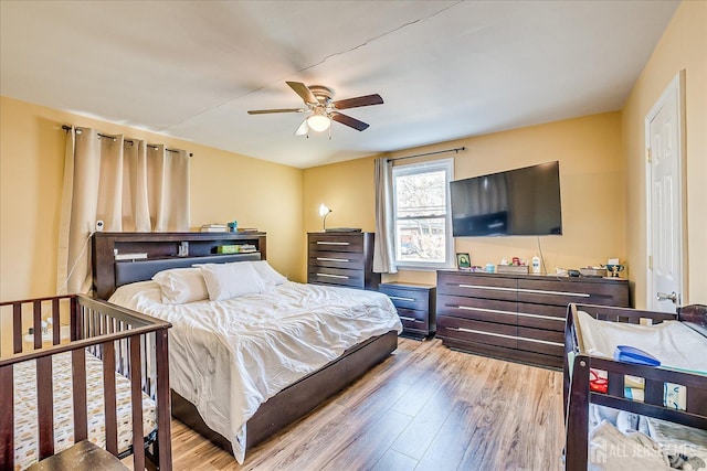 bedroom featuring light hardwood / wood-style flooring and ceiling fan