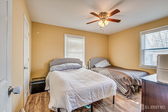 bedroom with light hardwood / wood-style floors and ceiling fan