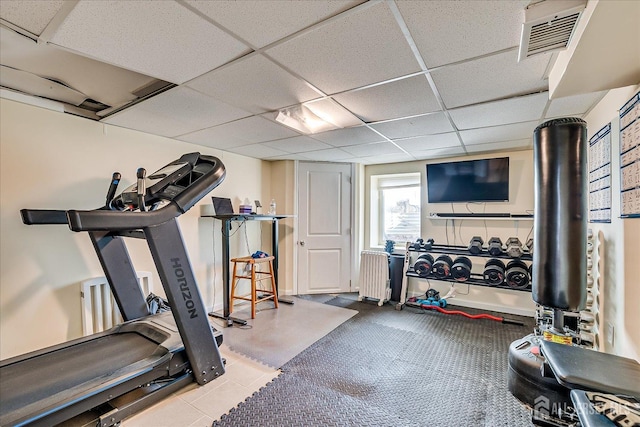 workout room featuring a drop ceiling