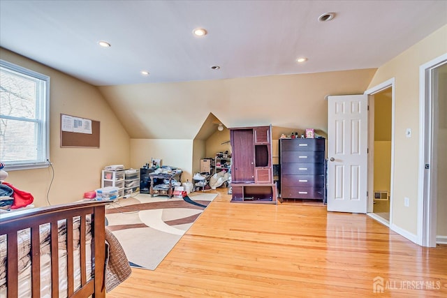 bedroom featuring wood-type flooring and lofted ceiling